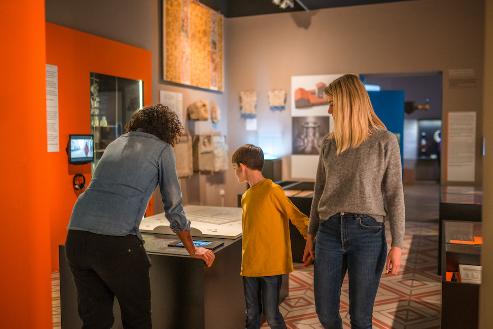 family looking at an exhibit in a museum