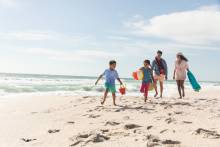 family on beach with kids