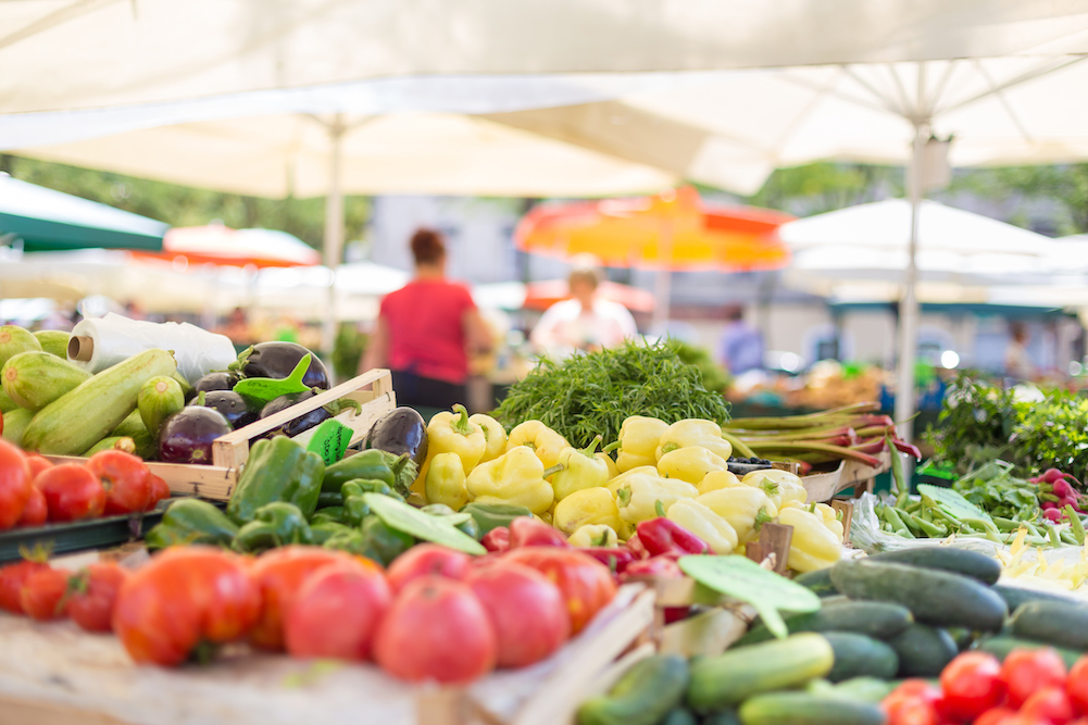 farmer's market booth with fresh vegetables 