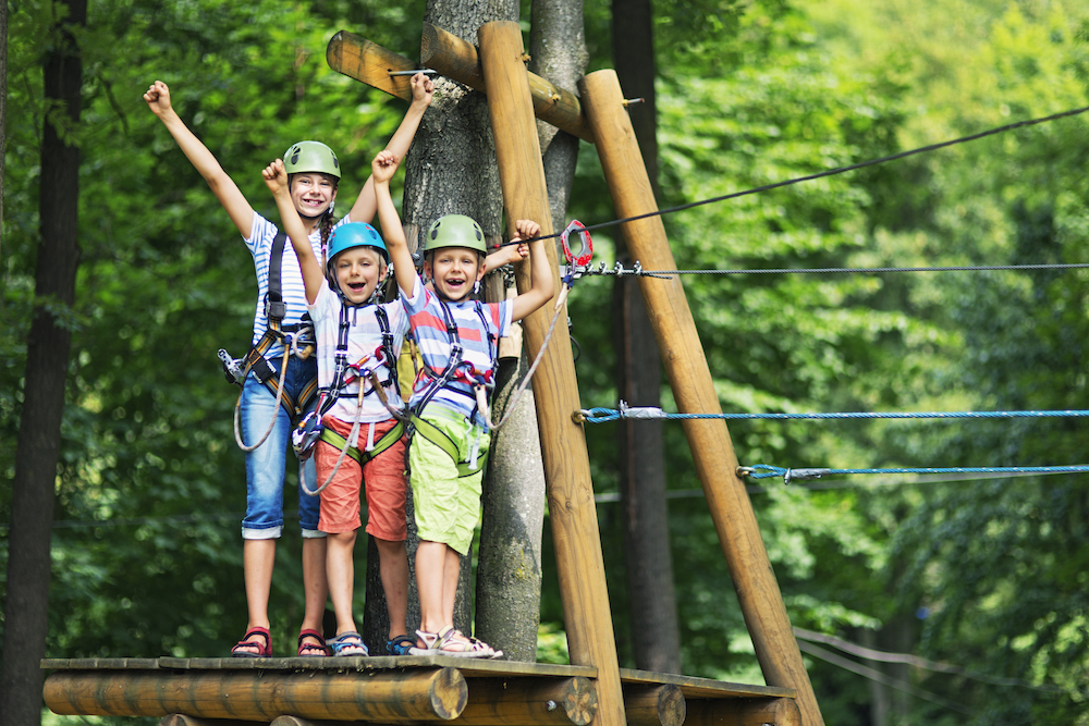 three kids doing a ropes course 