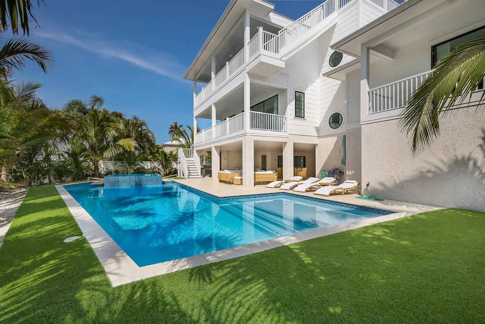 exterior of The Colony vacation rental in anna maria island showing beautiful in-ground pool